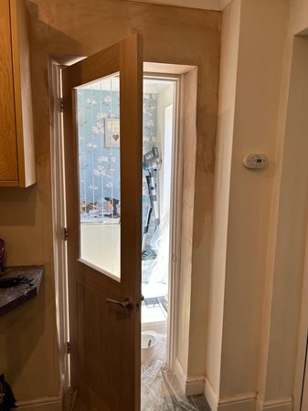 Removal of arch, plastering, door frame and oak door fitting.